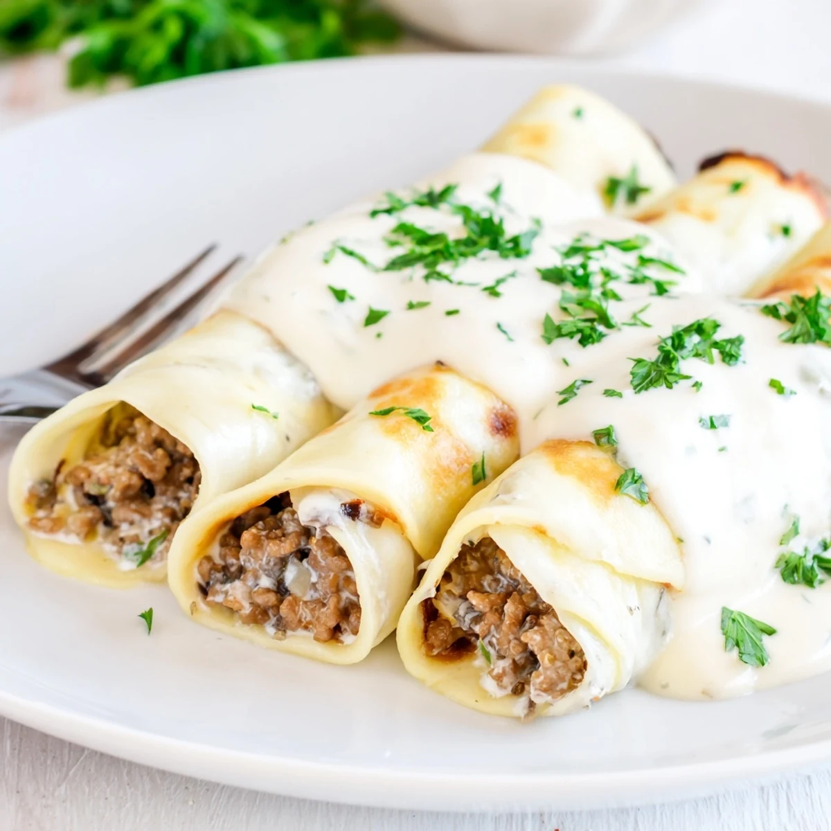 Comforting Hortobágyi palacsinta featuring tender stuffed crepes topped with rich paprika-infused cream sauce