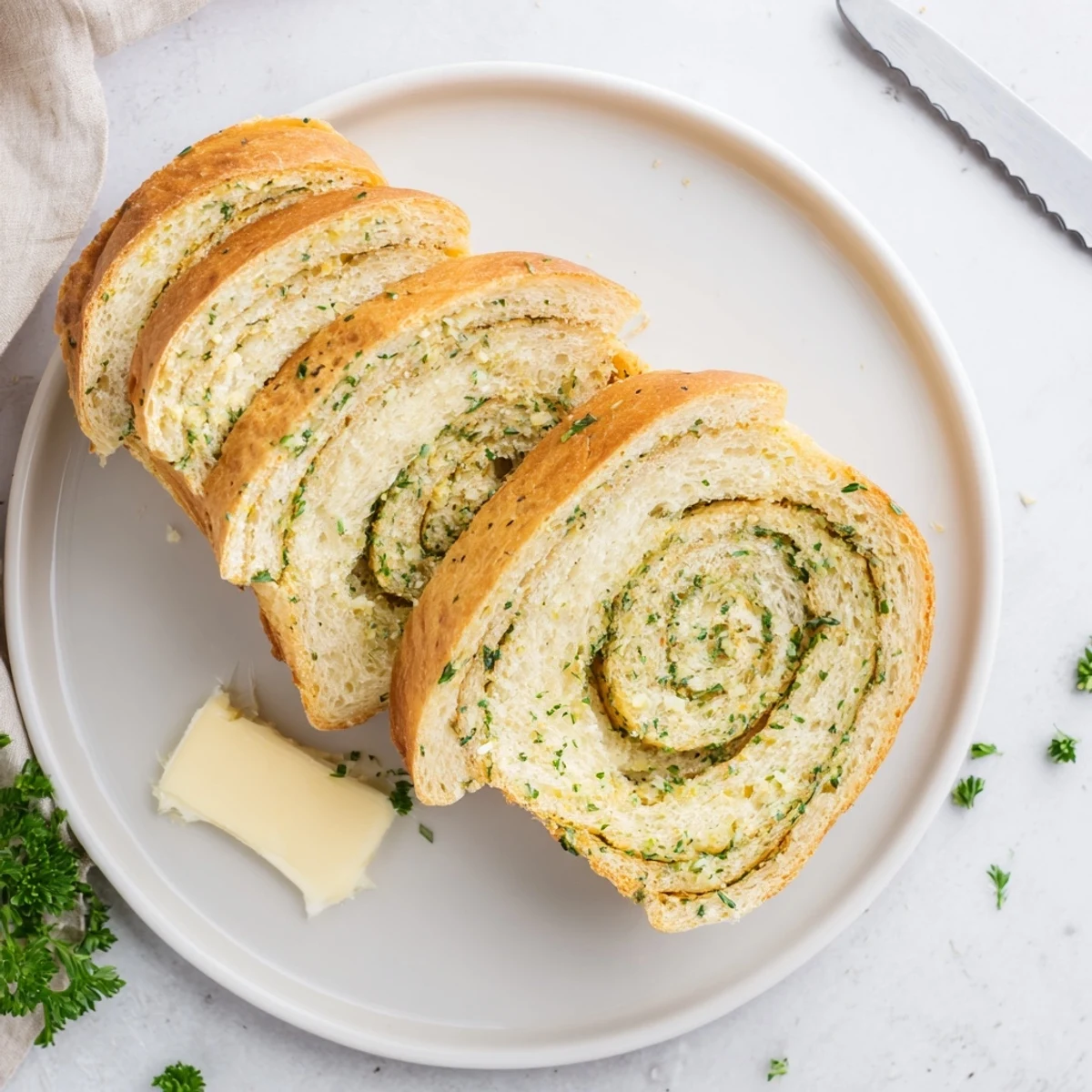 Warm sliced garlic and herb bread on a wooden board ready for serving