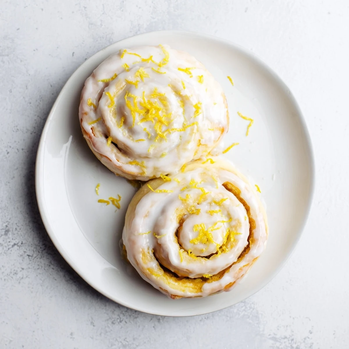 Soft homemade lemon rolls sliced open revealing buttery lemon sugar swirl filling