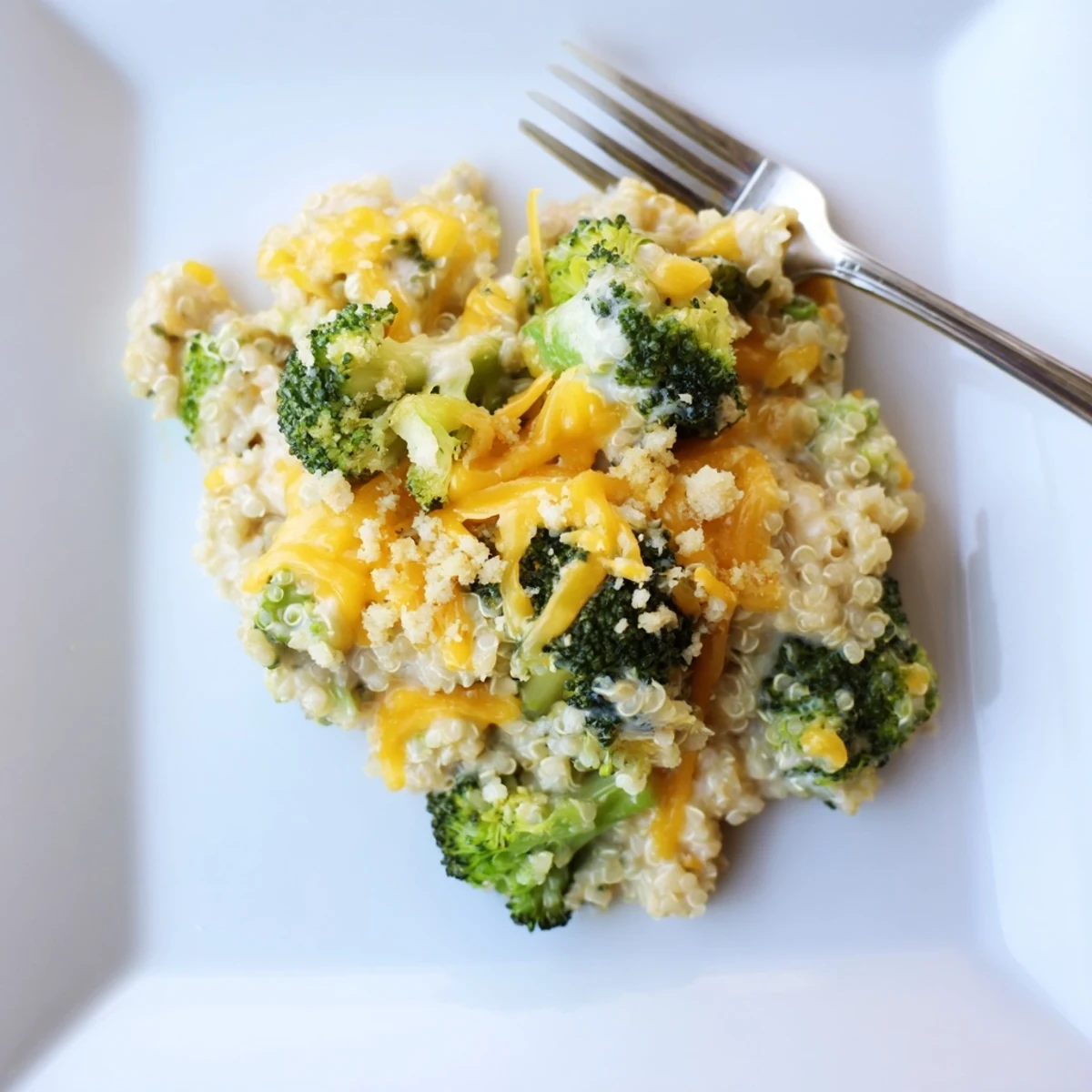 Vegetarian creamy broccoli quinoa casserole served warm in a cozy 9x13 baking dish
