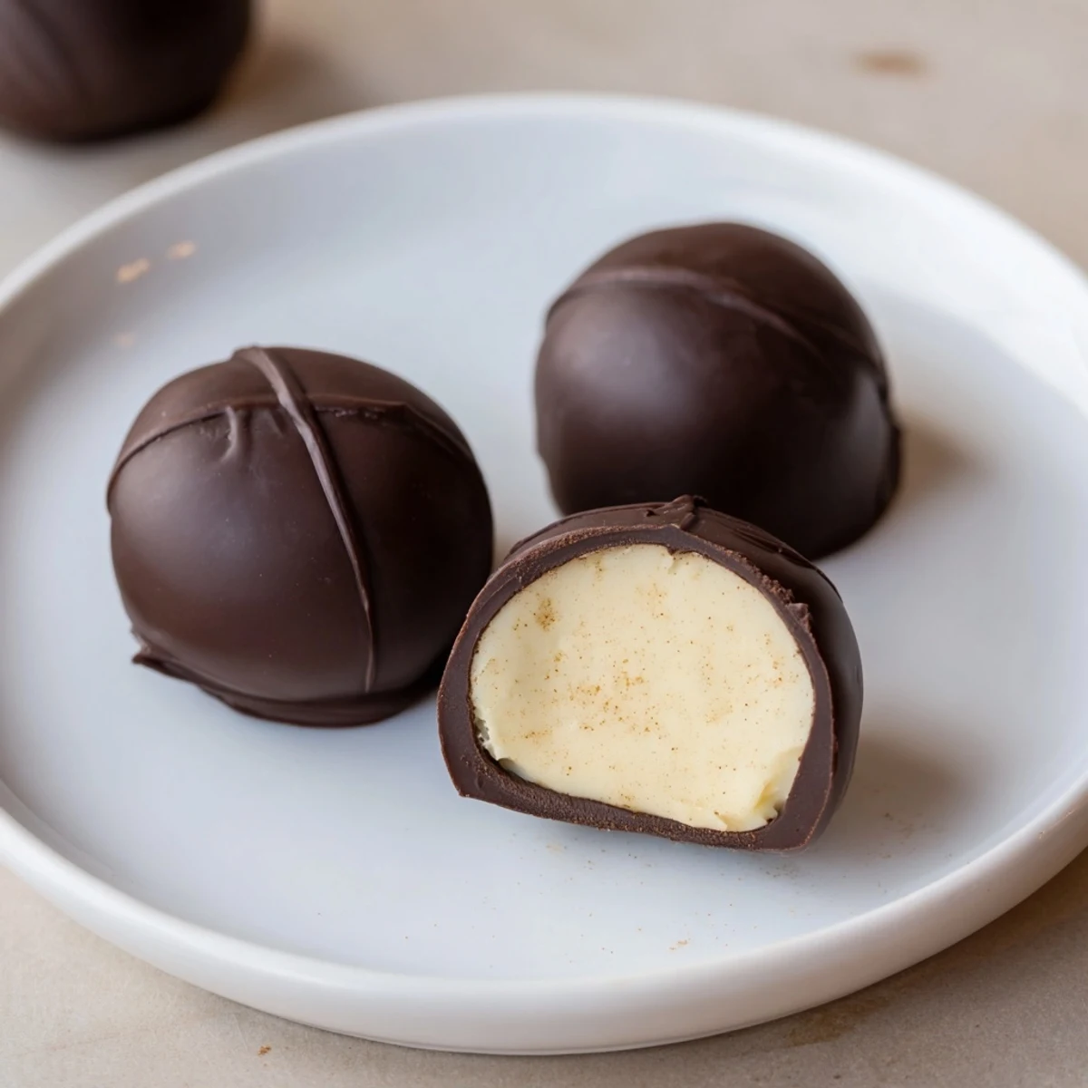 Warm kitchen scene showing Dark Chocolate Eggnog Truffles dusted with nutmeg.  