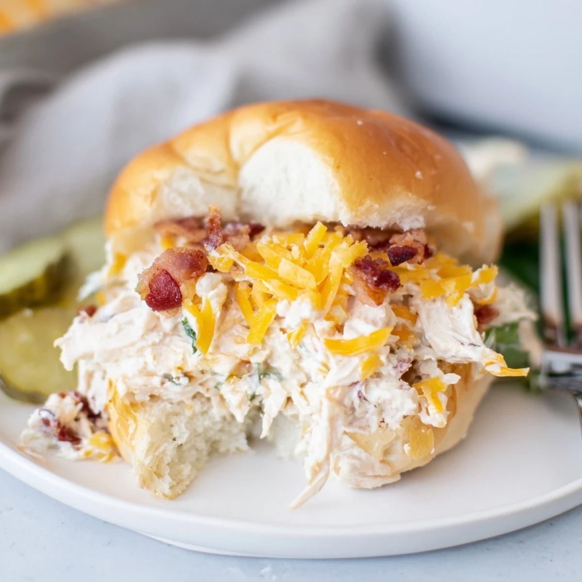 Creamy, cheesy Crack Chicken Sandwiches topped with crispy bacon, served warm.