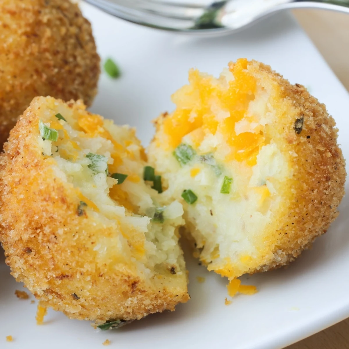 Close-up of Fried Mashed Potato Balls piled on plate with ranch dip