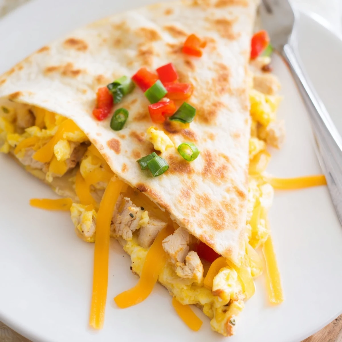 Golden, crispy Chicken Breakfast Quesadilla filled with melty cheddar and scrambled eggs