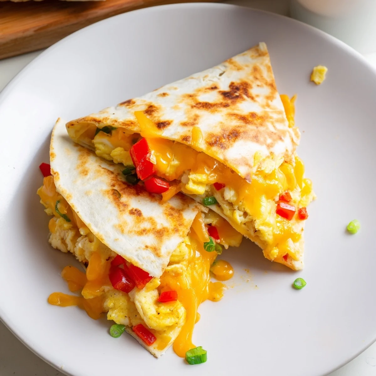 Sliced Chicken Breakfast Quesadilla on plate, steam rising, avocado slices suggested