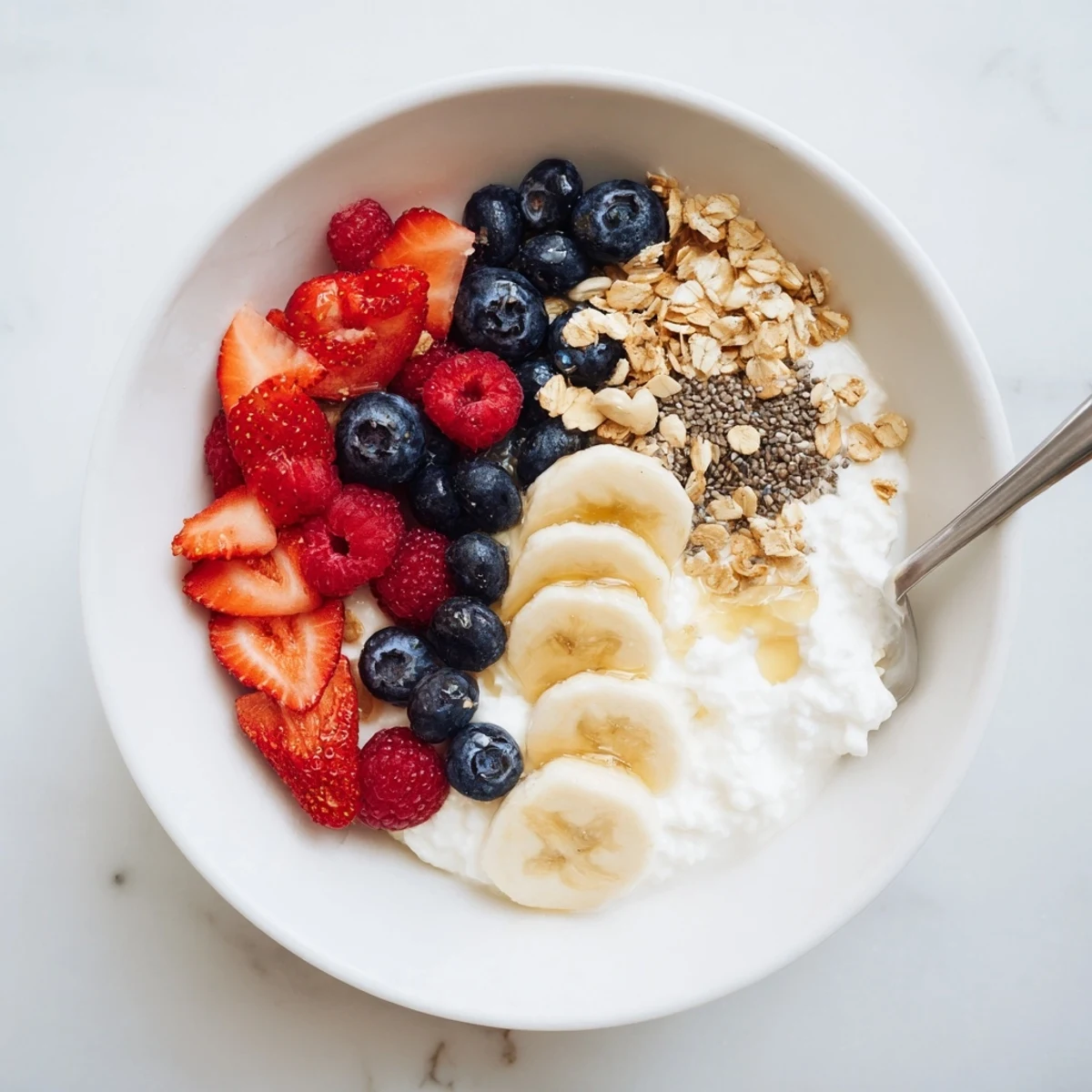 Creamy Cottage Cheese Breakfast Bowl topped with juicy berries, crunchy granola