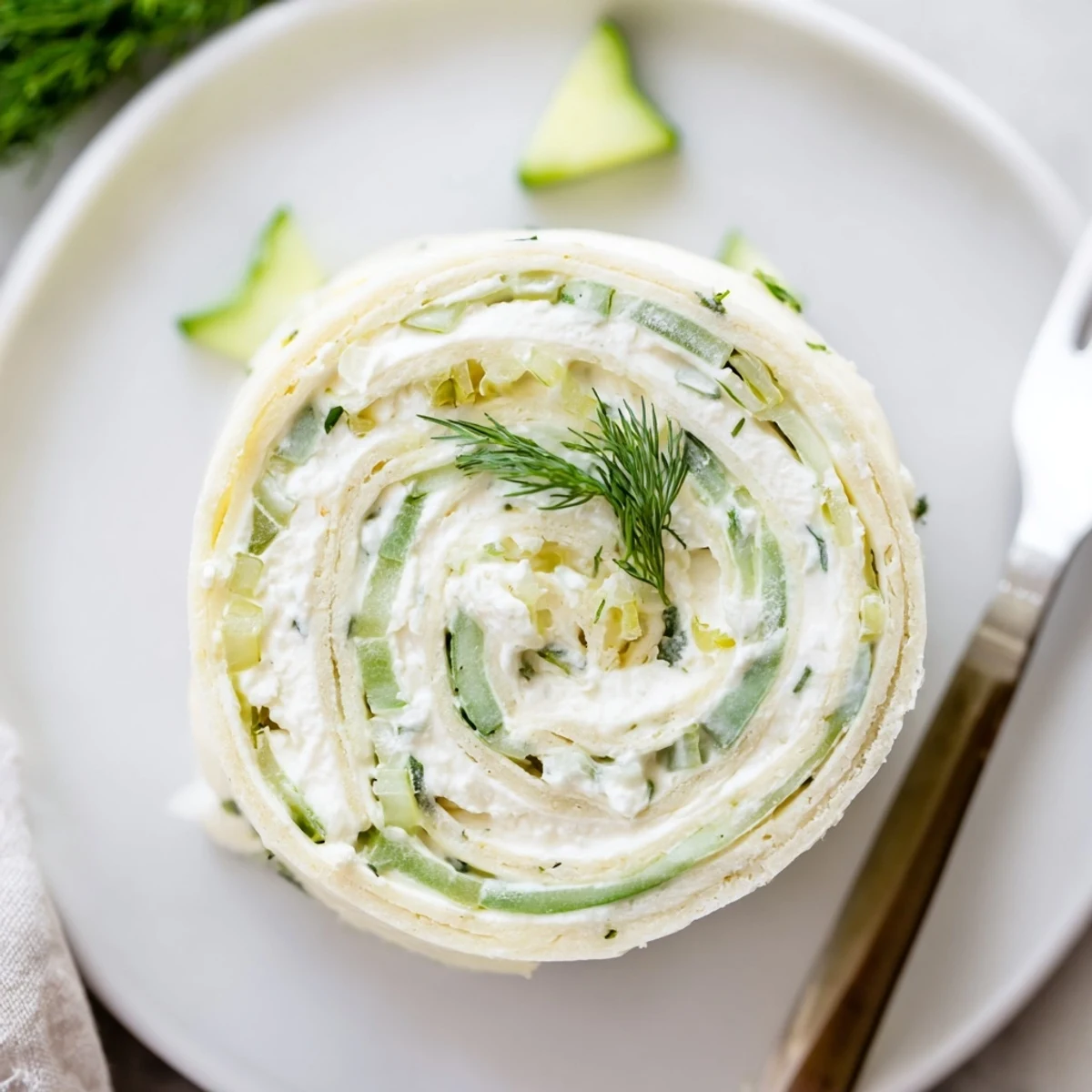 Pickle Dip Pinwheels chilled on a platter, creamy filling and dill aroma  