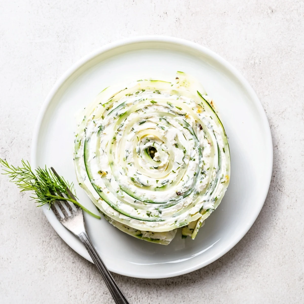 Cucumber And Dill Pinwheels on a chilled platter, creamy filling, crisp cucumber