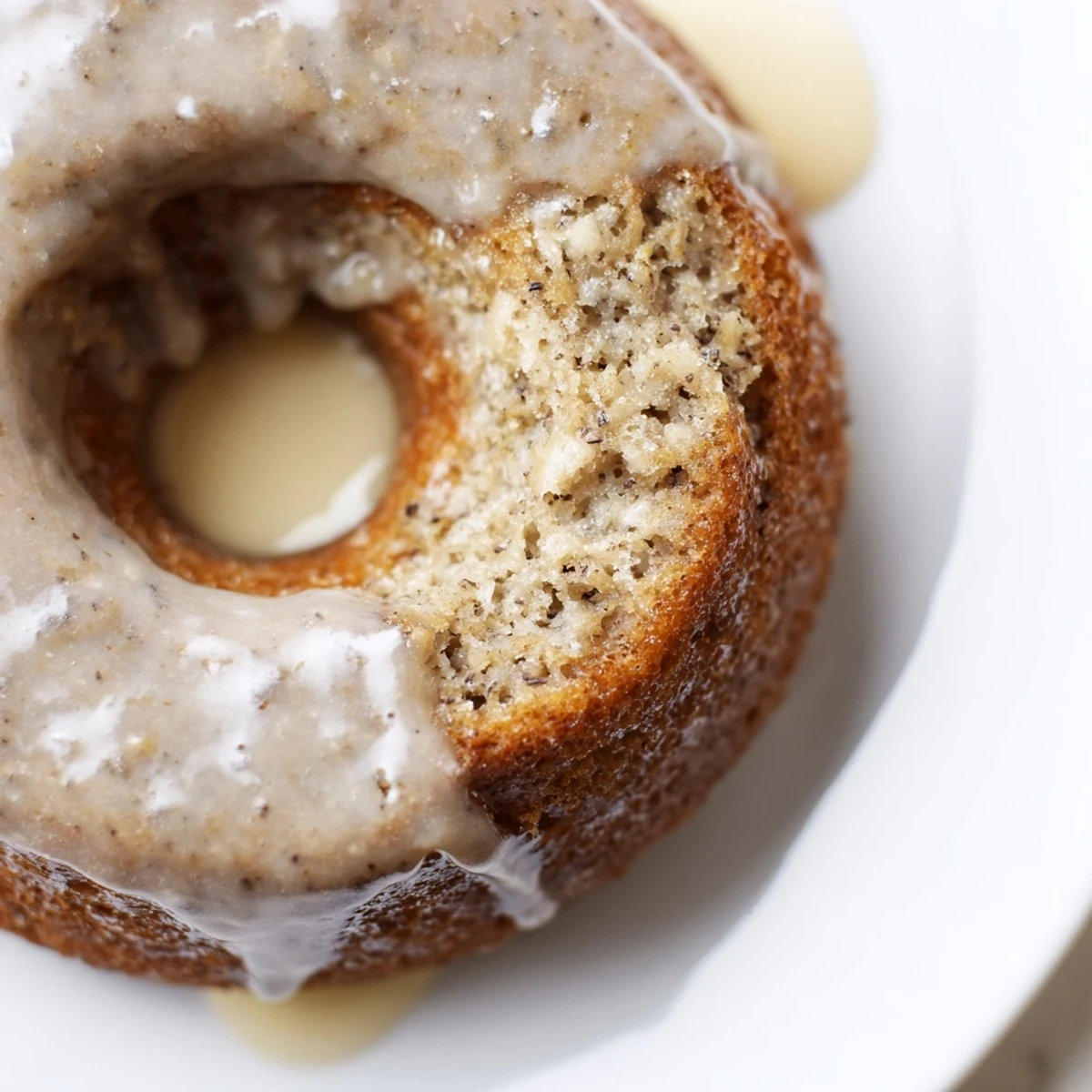 Moist cake like Banana Donuts cooling on a rack, awaiting sweet glaze