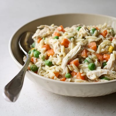 One-pot creamy chicken pot pie orzo loaded with tender chicken and colorful vegetables.
